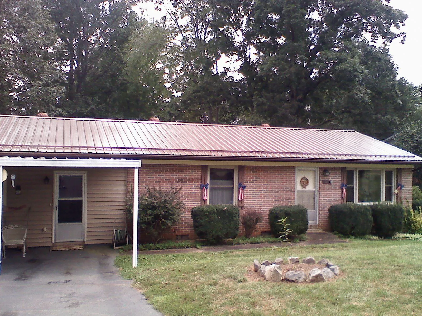 Bronze metal roof and carport on a brick ranch home — Roof Repair work by our crew in Shelton